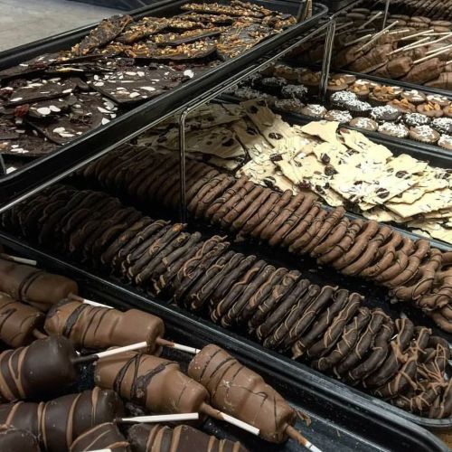 A display of various chocolate treats, including bars, cookies, and chocolate-covered snacks.