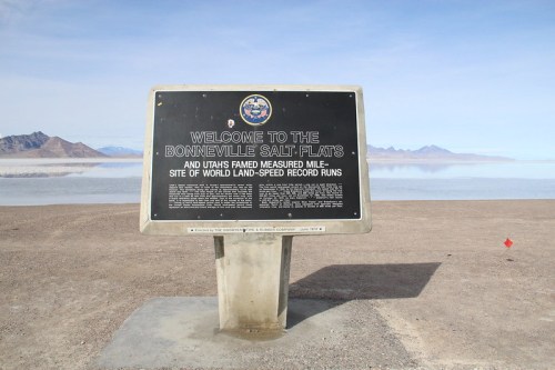 Sign at Bonneville Salt Flats, welcoming visitors and noting its history as a site for land-speed record runs.