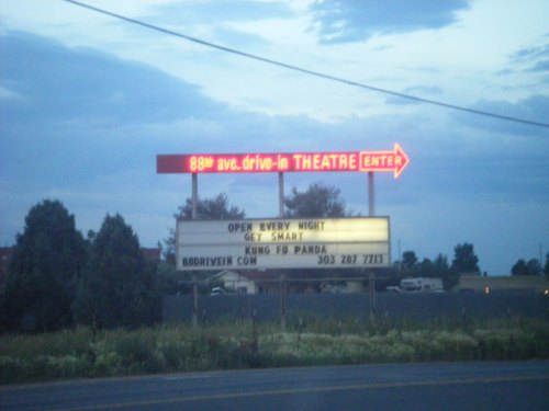 Sign for a drive-in theater displaying "Open Every Night," "Get Smart," and "Kung Fu Panda" with an arrow pointing to the entrance.