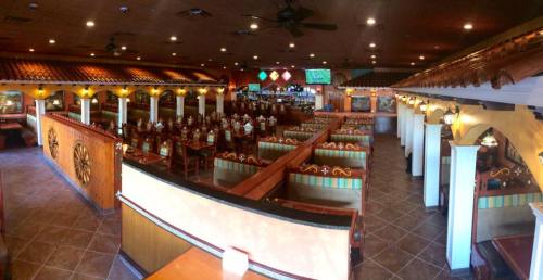 Interior of a vibrant restaurant with colorful seating, wooden accents, and a lively atmosphere.