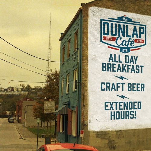 A mural on a building advertising Dunlap Café, featuring all-day breakfast, craft beer, and extended hours.