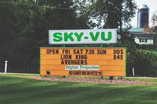 Sign for Sky-Vu theater showing "Lion King" and "Avengers," open Friday to Sunday, with digital projection.