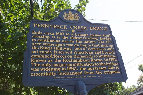 Historical marker for Pennypack Creek Bridge, detailing its construction and significance as an old roadway bridge.