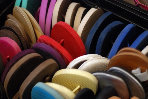 A colorful assortment of flip-flops arranged neatly in a display, showcasing various styles and colors.