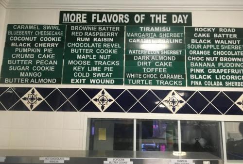 Menu board displaying various ice cream flavors of the day, including options like caramel swirl, tiramisu, and rocky road.