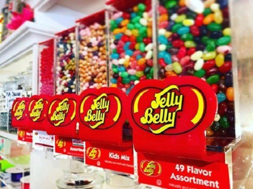 Colorful Jelly Belly jelly beans displayed in clear containers, featuring various flavors and a vibrant assortment.