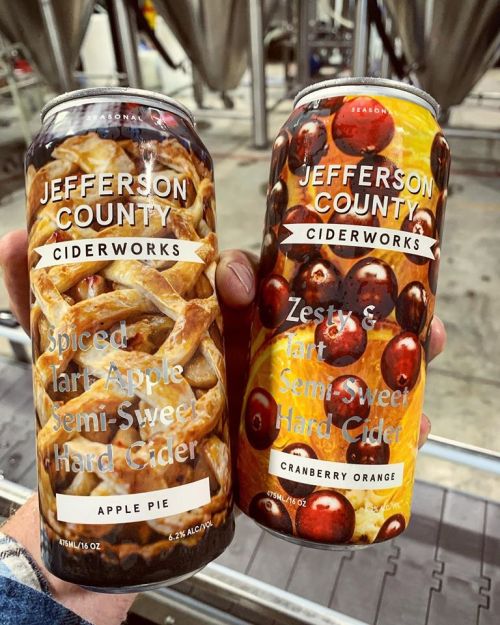 Two cans of hard cider from Jefferson County Ciderworks: Spiced Tart Apple and Zesty Tart Cranberry Orange.
