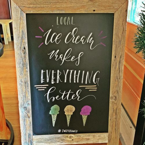 Chalkboard sign reads: "Local ice cream makes everything better" with illustrations of three ice cream cones.