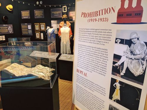 Exhibit on Prohibition (1919-1933) featuring flapper dresses, artifacts, and informative displays about the era.