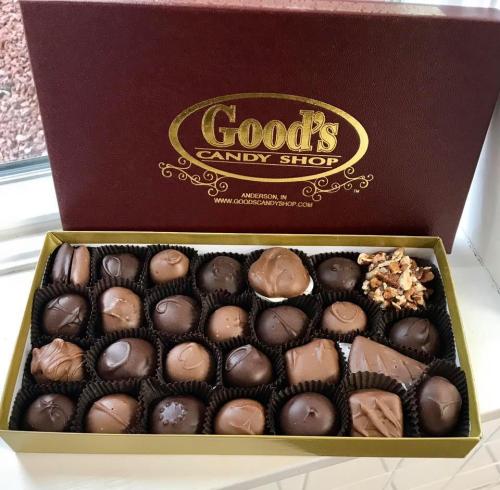 A box of assorted chocolates from Good's Candy Shop, featuring various shapes and fillings, with a decorative lid.
