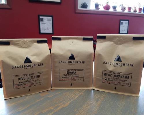 Three coffee bags from Dagger Mountain Roastery, labeled with origins: D.R. Congo, Costa Rica, and Rwanda.
