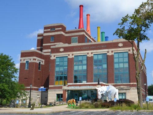 A brick building with colorful smokestacks, labeled "City Light and Power," housing Science Central.