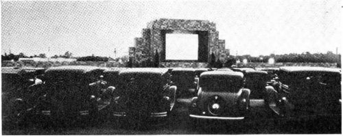 A vintage drive-in theater scene with classic cars parked in front of a large screen.