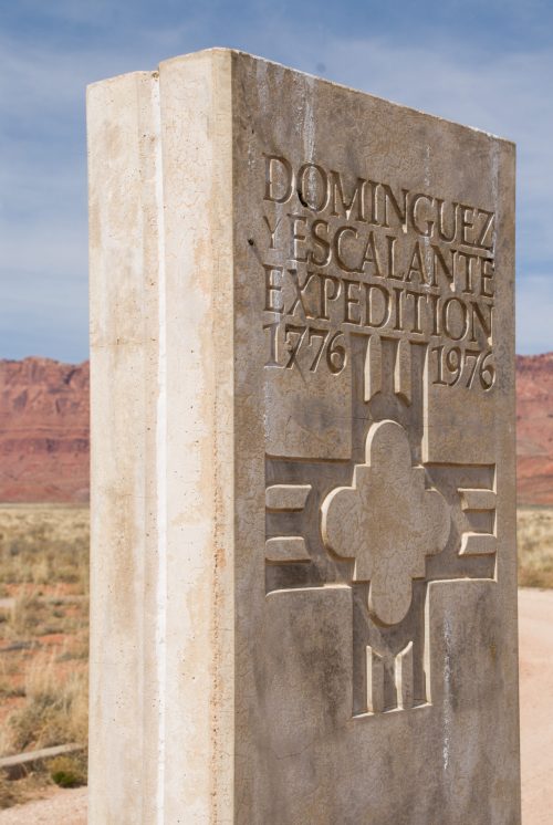 Monument commemorating the Dominguez-Escalante Expedition, marked with dates 1776 and 1976, set against a desert landscape.