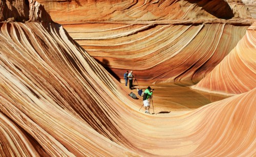 Two photographers capture the colorful, wavy rock formations of The Wave in Arizona's Coyote Buttes.