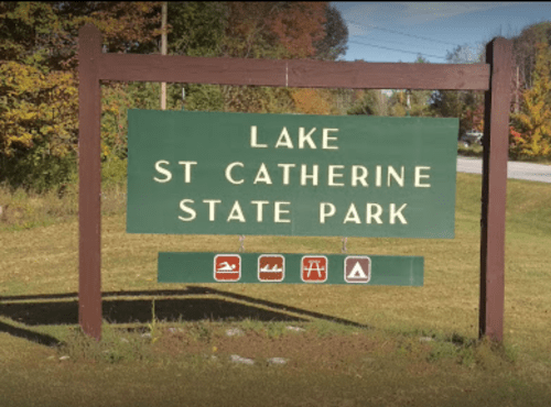 Sign for Lake St. Catherine State Park, featuring icons for swimming, picnicking, and camping.