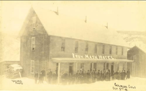 Historic photo of the Iron Mask Hotel in Gilman, Colorado, with a group of people standing in front, dated October 5, 1896.