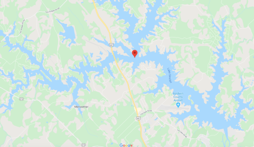 Map showing a lake area with roads and a red marker indicating a specific location.