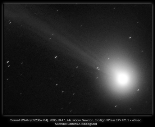 Image of Comet SWAN (C/2006 M4) with a bright nucleus and a long tail, captured through a telescope.