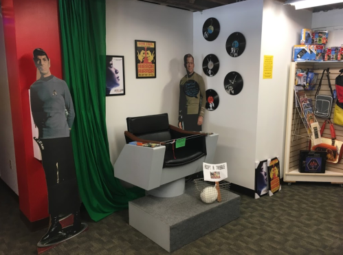 A themed room featuring Star Trek cutouts, a replica captain's chair, and vintage memorabilia on display.