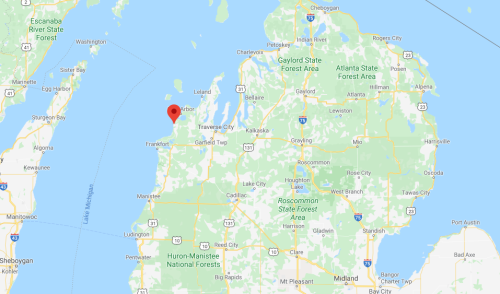 Map showing a location marked in red on the northwest coast of Michigan, near Lake Michigan.