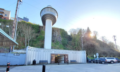 Oregon City Municipal Elevator building with a tall, cylindrical tower and surrounding greenery.
