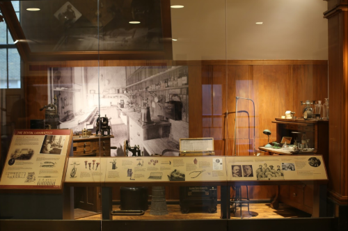 A historical dental laboratory display featuring vintage tools, equipment, and informational panels.