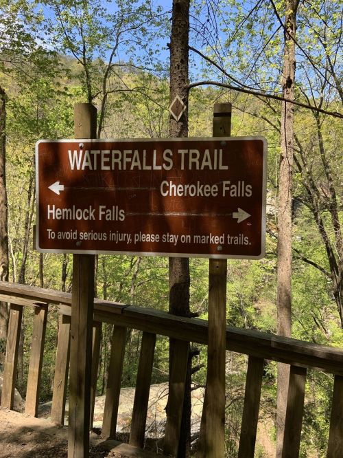 Sign for Waterfalls Trail, indicating Hemlock Falls and Cherokee Falls, with a warning to stay on marked trails.