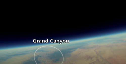 A view of Earth from space highlighting the Grand Canyon, with a dark sky above and a curved horizon.
