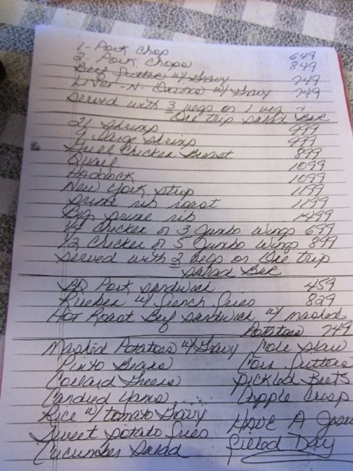 A handwritten menu with various food items and prices, including appetizers, chicken dishes, and sides.