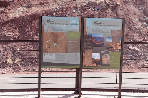 Two informational signs at a park, displaying maps and details about the Lion's Park and scenic byways.