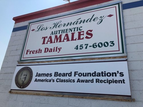 Sign for "Los Hernández Tamales" featuring "Authentic Tamales" and recognition from the James Beard Foundation.