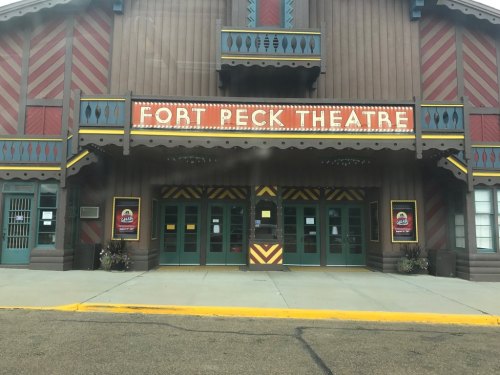 Front view of Fort Peck Theatre, featuring colorful signage and a decorative facade.