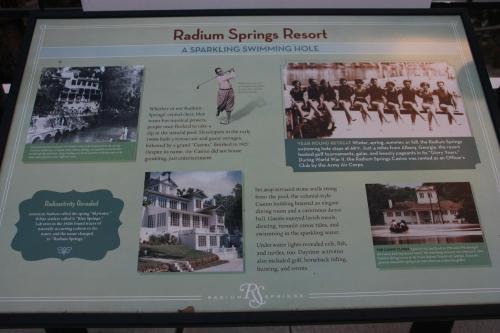 Sign about Radium Springs Resort, highlighting its history, swimming activities, and entertainment options.