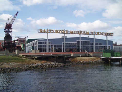 Exterior view of the Baltimore Museum of Industry, featuring a large sign and a waterfront setting.