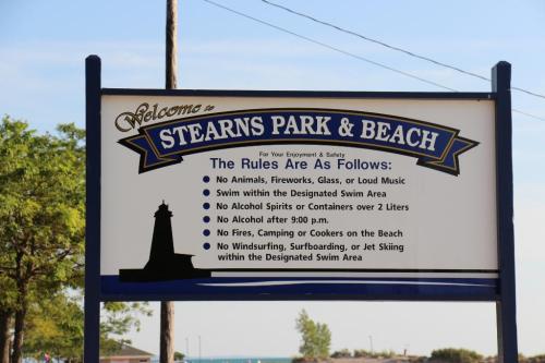 Sign at Stearns Park & Beach outlining rules: no animals, alcohol, fires, or water sports outside designated areas.