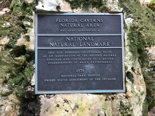 Plaque marking Florida Caverns Natural Area as a National Natural Landmark, highlighting its environmental significance.