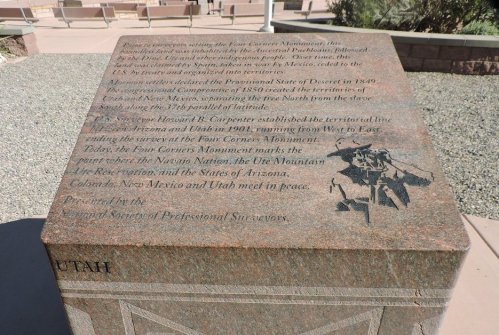 A stone monument detailing the Four Corners region's history and state boundaries, with an engraved map and text.