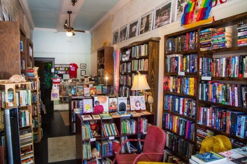 A cozy bookstore filled with shelves of books, a reading chair, and colorful decor, creating a warm, inviting atmosphere.