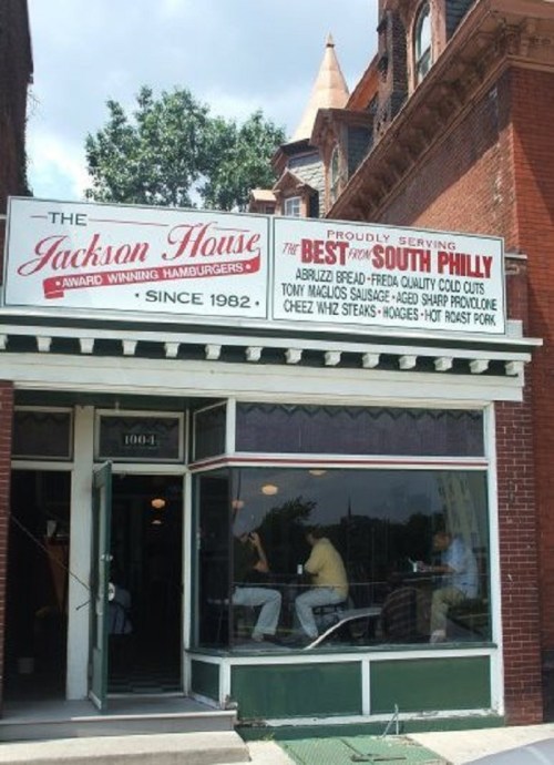 Exterior of The Jackson House, a restaurant with a sign highlighting its award-winning hamburgers and menu items.
