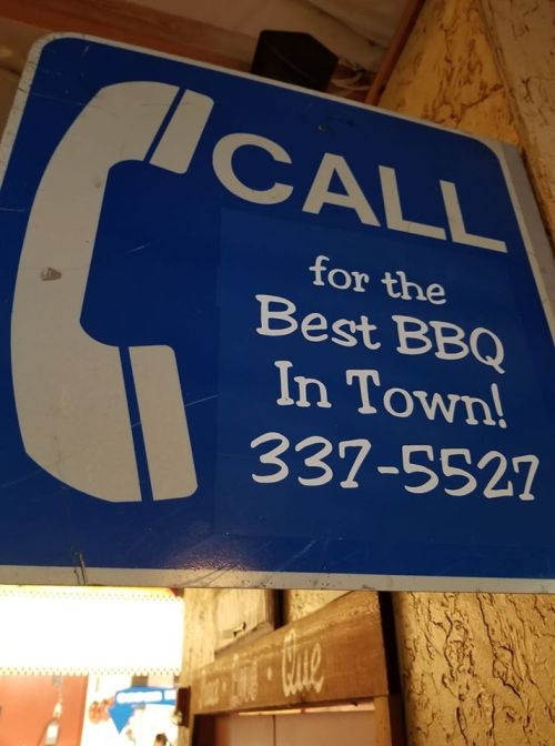 Blue sign with a phone graphic, reading "CALL for the Best BBQ In Town! 337-5527."