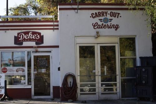Exterior view of Deke's Barbecue and Carry-Out Catering, featuring signage and large windows.