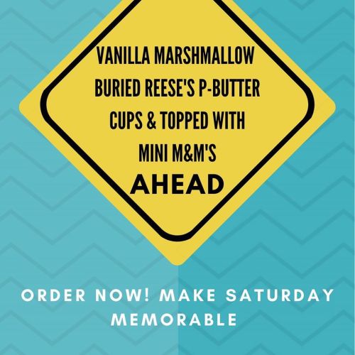 Sign promoting a dessert with vanilla marshmallow, Reese's cups, and mini M&M's. Encourages ordering for a memorable Saturday.