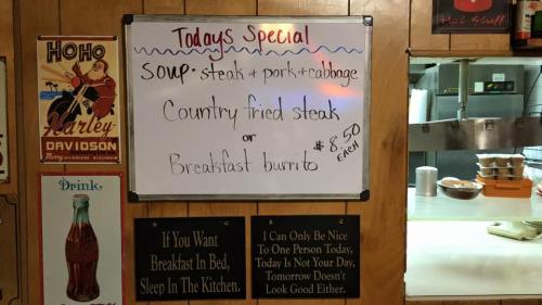Menu board listing today's specials: soup (steak, pork, cabbage), country fried steak, or breakfast burrito, each $8.50.