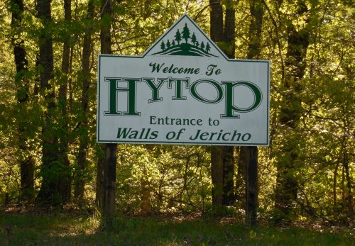 Welcome sign for Hytop, with "Entrance to Walls of Jericho" beneath, surrounded by lush green trees.