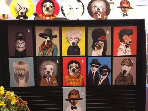 A display of quirky pet portraits featuring dogs in various costumes and styles, arranged in a grid format.