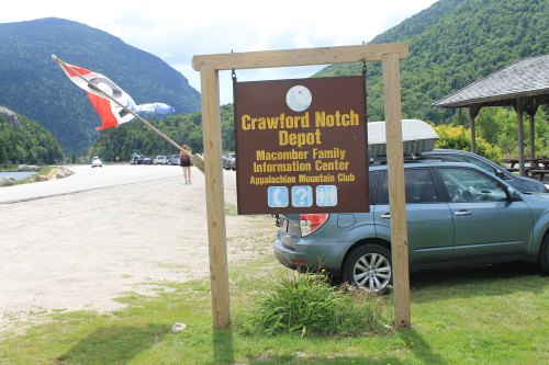Sign for Crawford Notch Depot with information about the Macomber Family Information Center and Appalachian Mountain Club.
