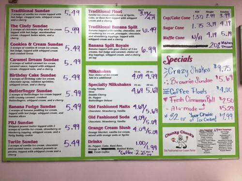 Menu board featuring ice cream sundaes, floats, milkshakes, and specials with prices listed.