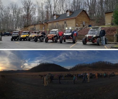 A group of ATV riders poses in front of cabins, with a sunset panorama and people gathered near horses below.