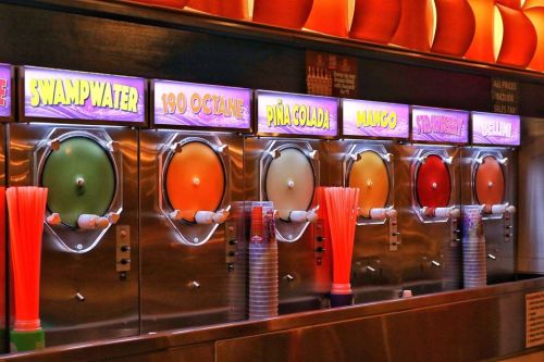 Colorful slushy machine with various flavors: Swampwater, 190 Octane, Piña Colada, Mango, Strawberry, and Jelly.